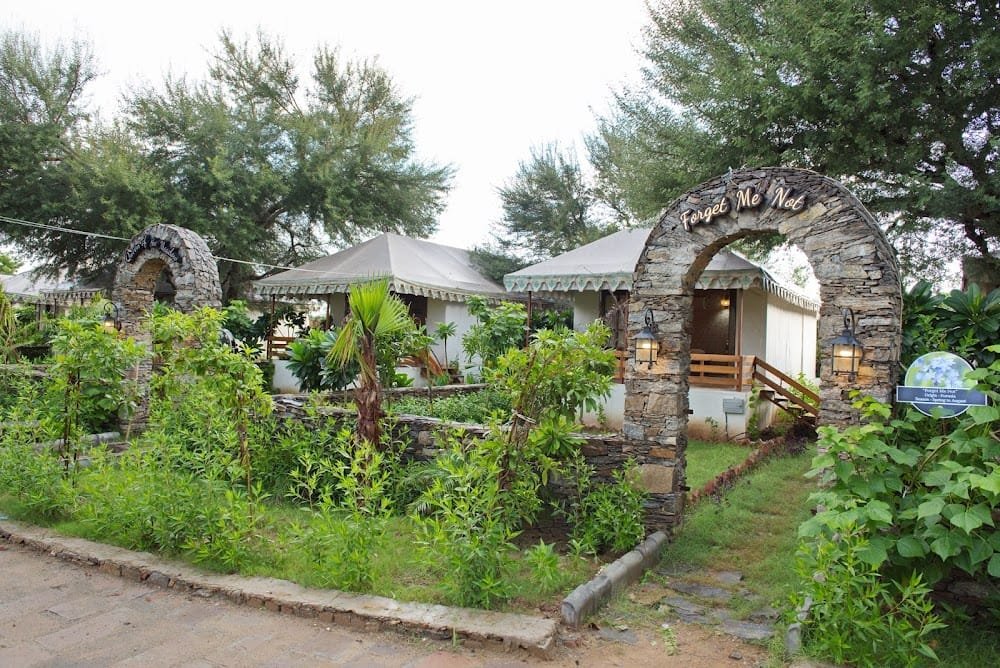 Stone archways leading to luxury tents